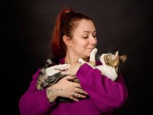 photographie en studio d'une maitresse faisant un câlin à son chat